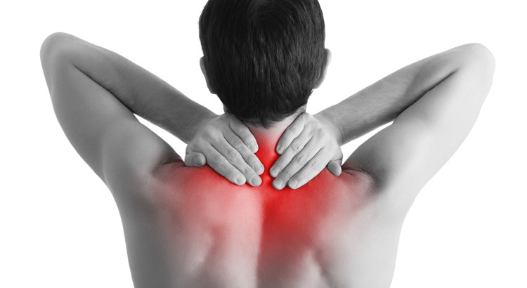 Rear view of a young man holding her neck in pain, isolated on white background, monochrome photo with red as a symbol for the hardening